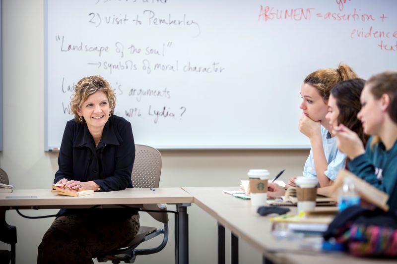 Dr. Drew Lamonica Arms teaching an honors course at LSU