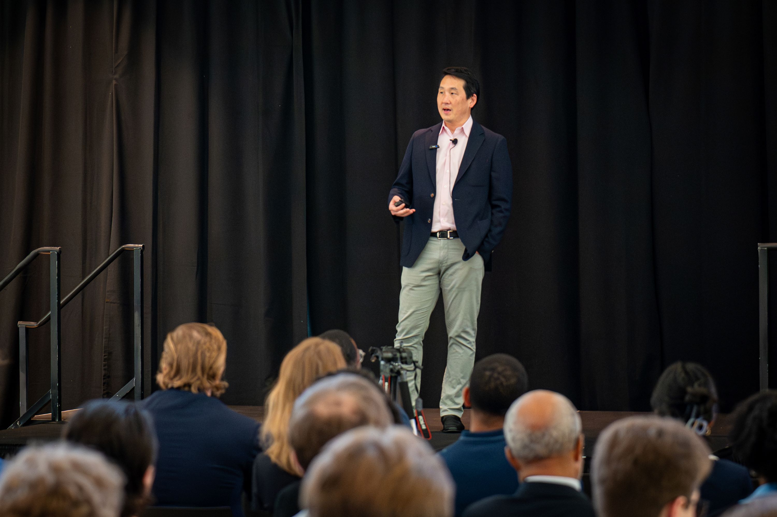 James Rhee on a stage speaking to an audience 