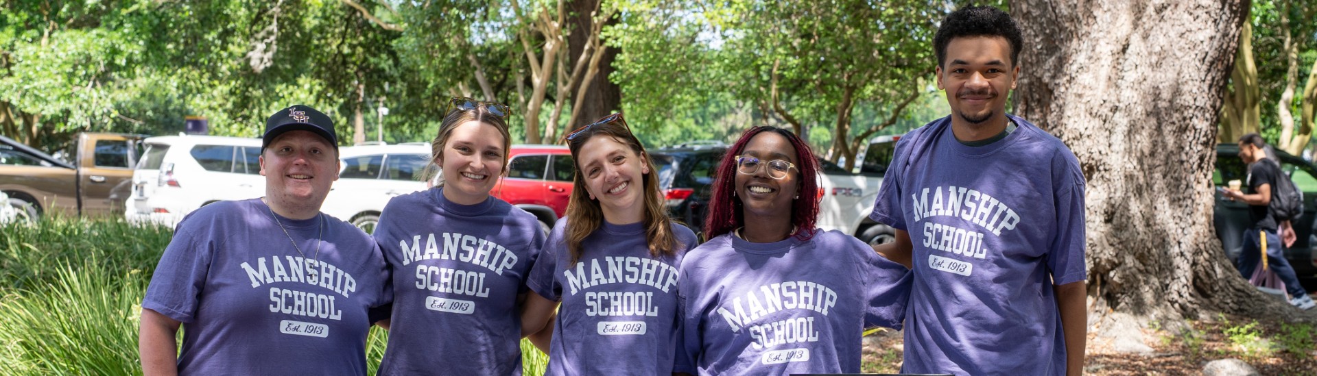 Manship students posing for a picture while all wearing matching Manship shirts